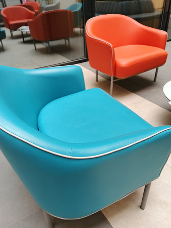 modern blue armchair in the lobby of a modern office or hotel