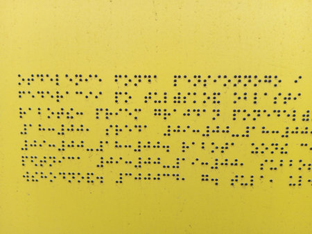 Alphabetic character on yellow background, closeup of photo.の写真素材
