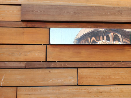 Wooden wall with mirror reflection in the window. Abstract background.