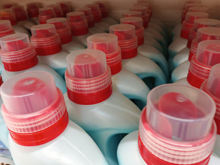 Plastic bottles of laundry detergent, bleach, dishwashing liquid