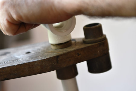 Close-up of a man's hand repairing a skateboard.