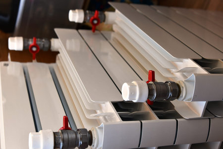Plastic heating radiator with fittings, close-up of photo
