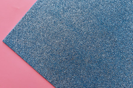 Blue carpet texture on pink background. Top view. Copy space.