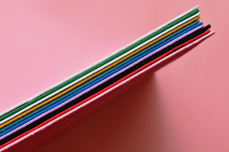 Colorful chopsticks on a pink background, close-up.
