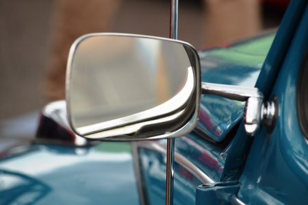 Detail of the rear view mirror of a classic american car