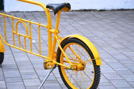 Yellow bicycle on the street, close-up, selective focus.の写真素材