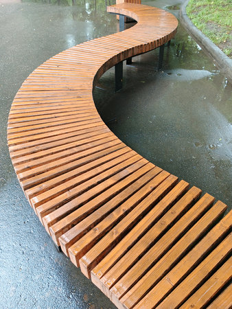 Wooden bench in the park, closeup photo with selective focusの写真素材