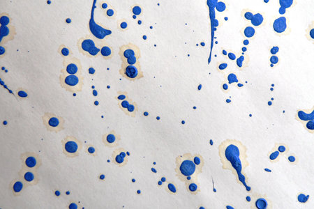 Blue ink blots on white paper. Abstract watercolor background.の写真素材