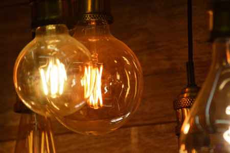 Vintage incandescent Edison light bulbs glowing in the dark.の写真素材
