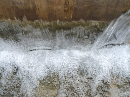 Water flowing from a waterfall in winter, close-up of photo