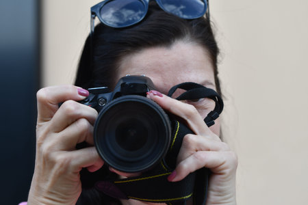 Young woman with a camera in her hands. Close-up.