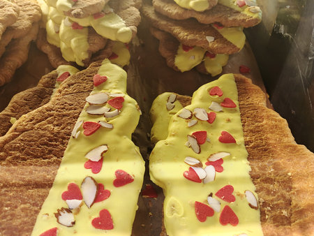 Eclairs with cream and nuts in the bakery shop window.