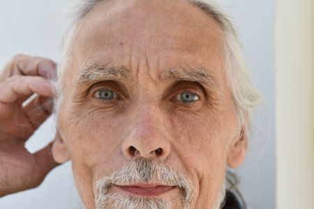 Portrait of an elderly man with a white beard and mustache.