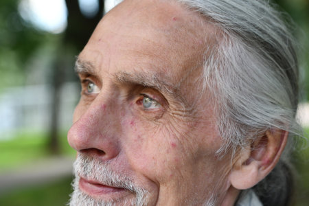 Portrait of a senior man with wrinkles on his forehead. Selective focus.の写真素材