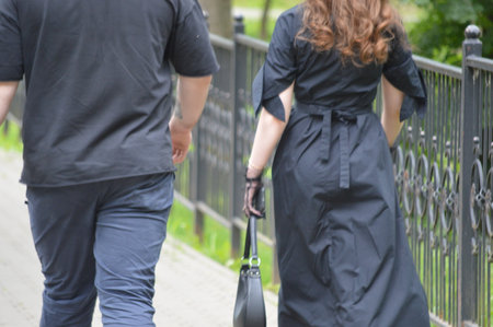 Couple walking in the park. A man and a woman are walking along the street.の写真素材