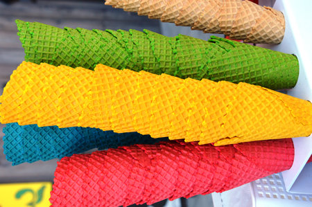 Colorful ice cream cones for sale in a street food market.