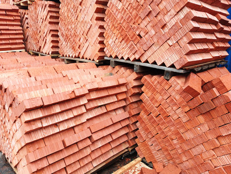 Stack of red bricks at a construction site, closeup of photoの写真素材