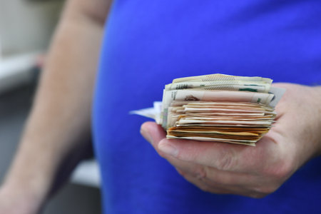 Pregnant woman with money in her hands. Selective focus.の写真素材