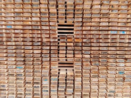 Wooden planks stacked in a warehouse, closeup of photoの写真素材