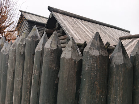Wooden fence on a cloudy day, close-up of photo