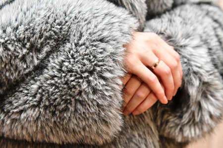 Female hands in fur coat, closeup view. Winter fashion.の写真素材