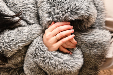 Close up of woman's hands in fur coat. Winter fashion.の写真素材