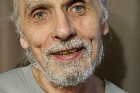 Portrait of an elderly man with gray hair and a white beardの写真素材