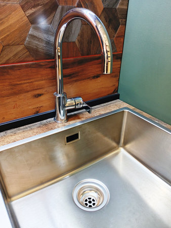 stainless steel faucet and sink in a modern kitchenの写真素材