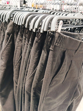 Men's jeans on hangers in the store. Selective focus.の写真素材