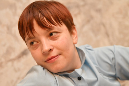 Portrait of a red-haired boy in a blue shirt.の写真素材