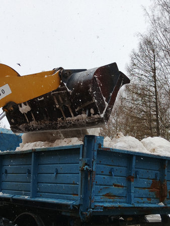 Snow removal equipment on the street in the winter. Heavy snowfall.