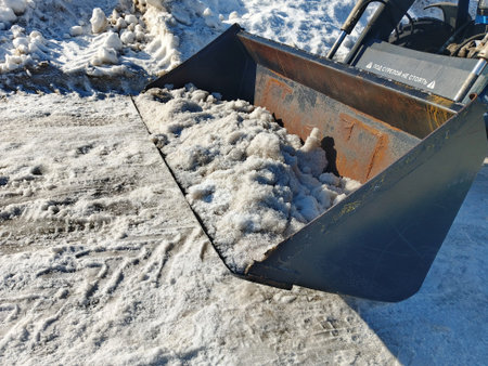 Snowplow cleans the road from snow in winter, closeup of photo