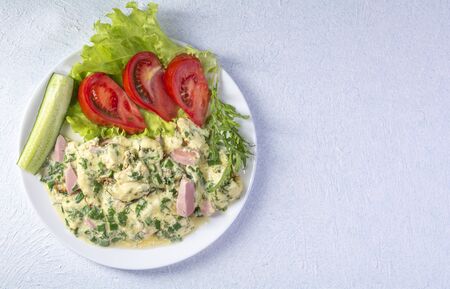 omelet on a plate with tomatoes, cucumber and lettuce, light texture backgroundの写真素材