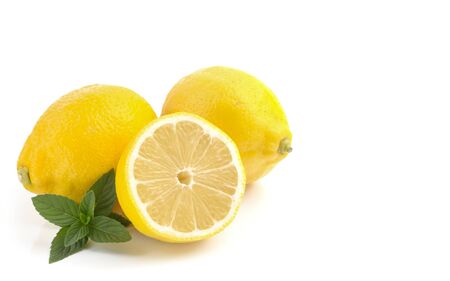 lemons whole and cut into slices, close-up on a white background, space for text, horizontal view, macroの写真素材