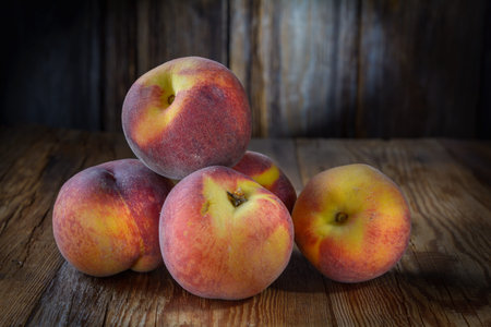 ripe peaches close-up on a dark wooden rustic background, horizontal viewの写真素材