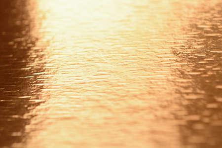 Shiny yellow gold foil sheet with gradient transition and shadows abstract background, Wallpaperの写真素材