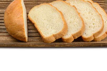 Slices of sliced bread lie in a wooden bread box.Isolated white background. Top view with copy...