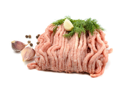 Fresh pork and beef minced meat, garnished with garlic, red pepper and dill.Isolated on a white background.の写真素材