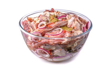 Pork ribs, sliced and marinated with onions, meat in a glass bowl, white isolated background, close-up.Selective Focus.の写真素材