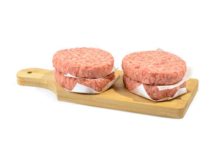 Raw beef patties for making a burger.Isolated on a white background.Selective Focus.の写真素材