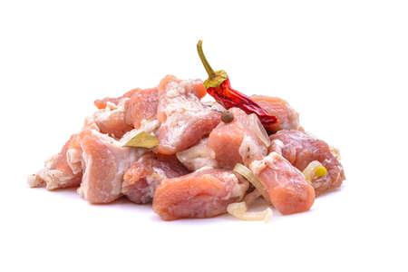 Raw pieces of pork shish kebab in marinade with pepper, onion,bay leaf, ready to cook, barbecue meat, isolated on a white background.の写真素材