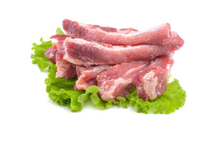 Raw pork ribs on a lettuce leaf are isolated on a white background.の写真素材