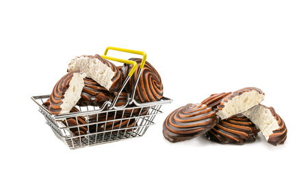 Chocolate-covered marshmallow close-up in a shopping basket, isolated on a white background. Selective focus.Horizontal view.の写真素材