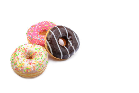 glazed donuts with bright colored sprinkles, isolated on a white background.