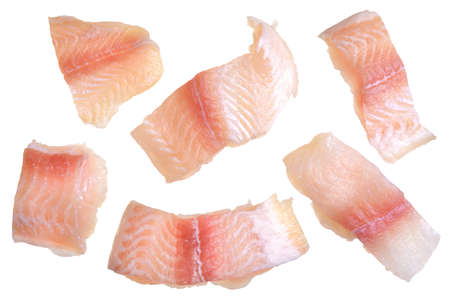 Pangasius fish fillet, pieces on a green lettuce leaf. Isolated on a white background. Fresh Fish Fillet. The view from the topの写真素材