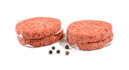 Raw beef patties for making a burger isolated on whiteの写真素材