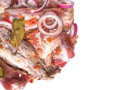 Pork ribs, sliced and marinated with onions, meat in a glass bowl, white isolated background, close-up., Top view, Selective Focus.の写真素材