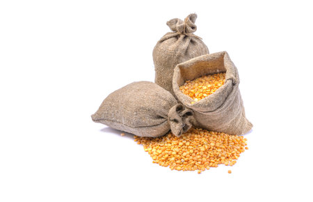 Peas in a bag, isolated on a white background. Split peas in burlap. Healthy food.Yellow split peas in a jute bag.Selective focus.horizontal view.の写真素材