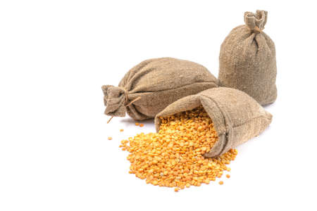 Peas in a bag, isolated on a white background. Split peas in burlap. Healthy food.Yellow split peas in a jute bag.Selective focus.horizontal view.の写真素材