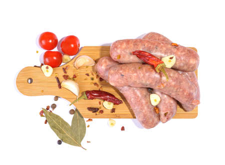 Raw pork sausages. Grilled sausages, spices close-up, isolated on a white background. Selective focus.Horizontal view.の写真素材